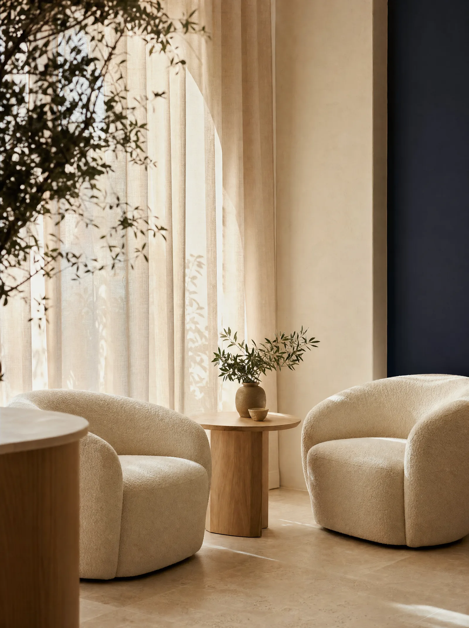 A quiet consultation corner with two soft chairs in warm window light
